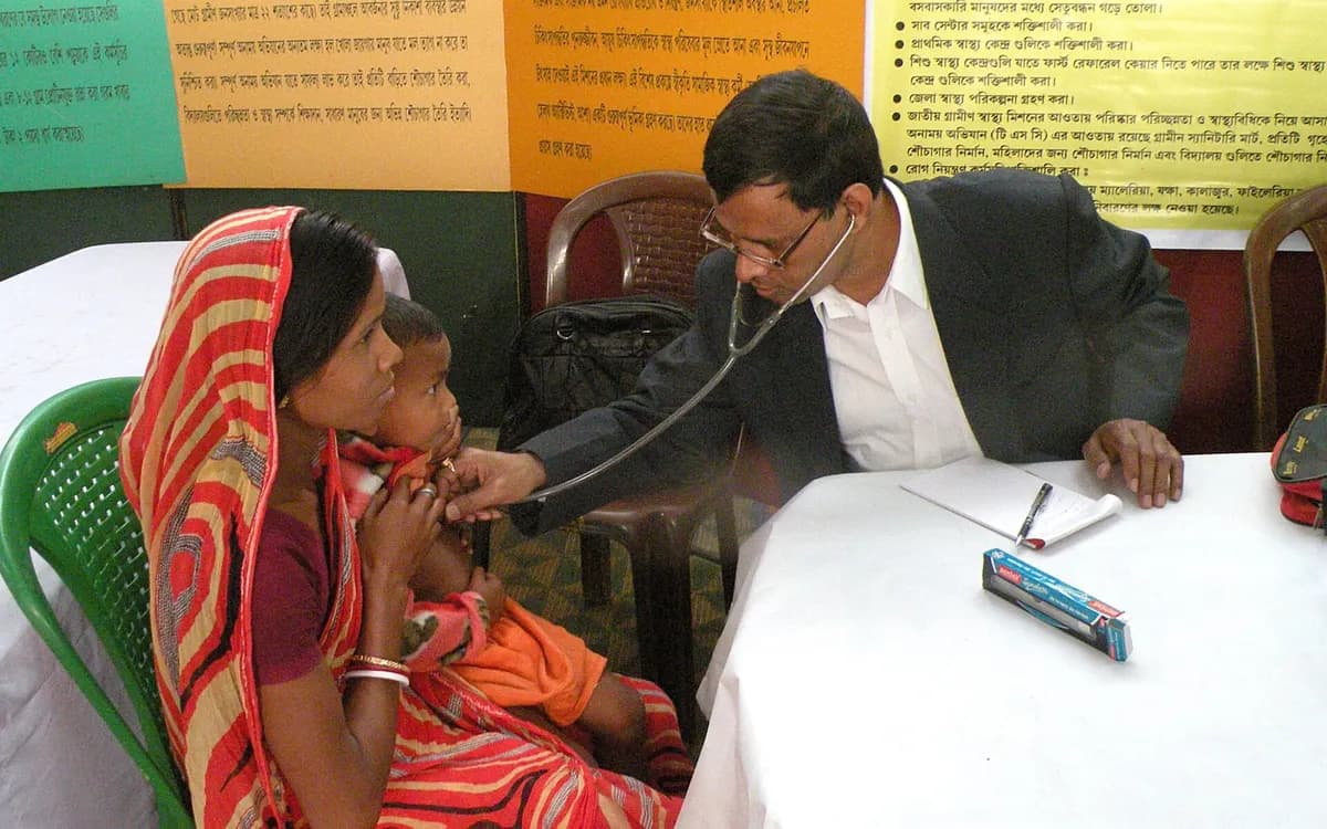 A doctor with a stethoscope examining a small child at a rural health centre